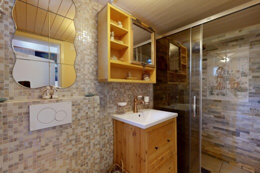 full bath with a shower stall, vanity, and tile walls