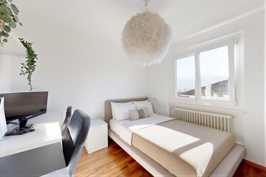 zimmer / schlafzimmer mit kühler, natural light, natürliches licht, wood finish floor, und holzfußboden