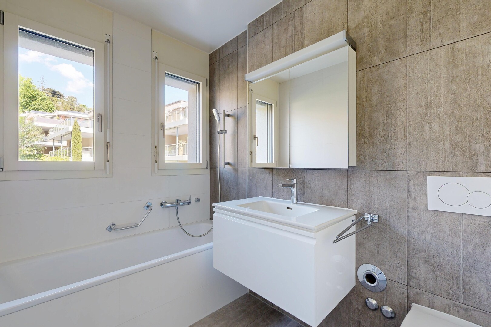 bathroom with tile walls, a garden tub, and vanity