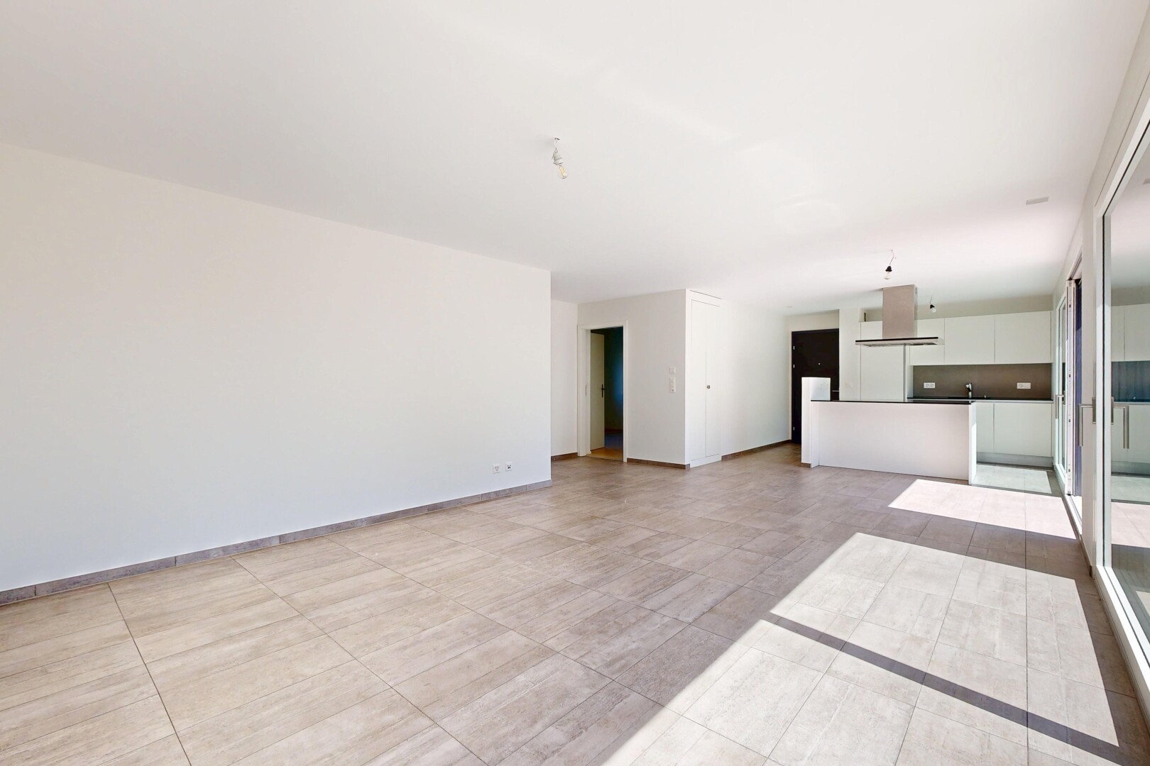 unfurnished living room featuring baseboards
