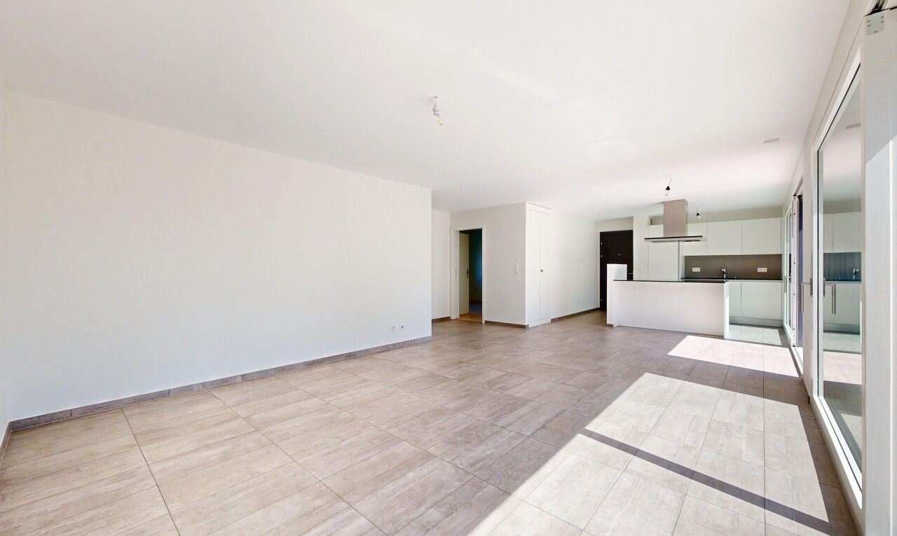 unfurnished living room featuring baseboards