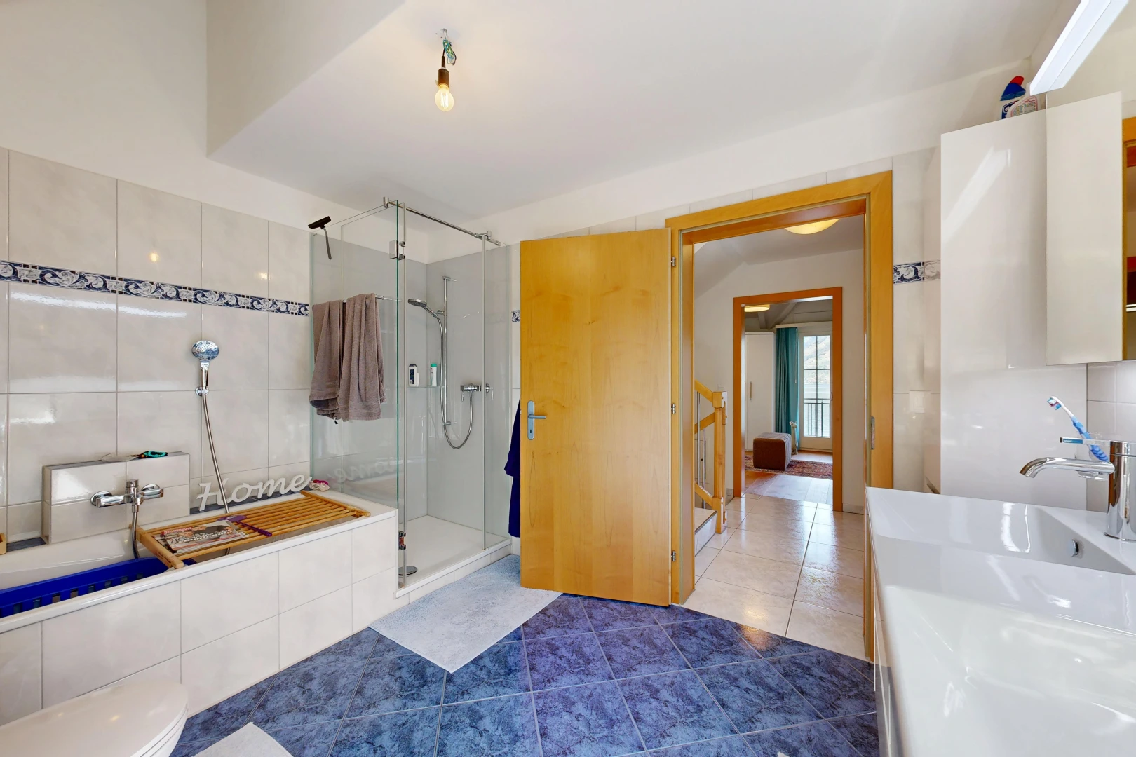 full bath with a stall shower, tile patterned floors, and vanity