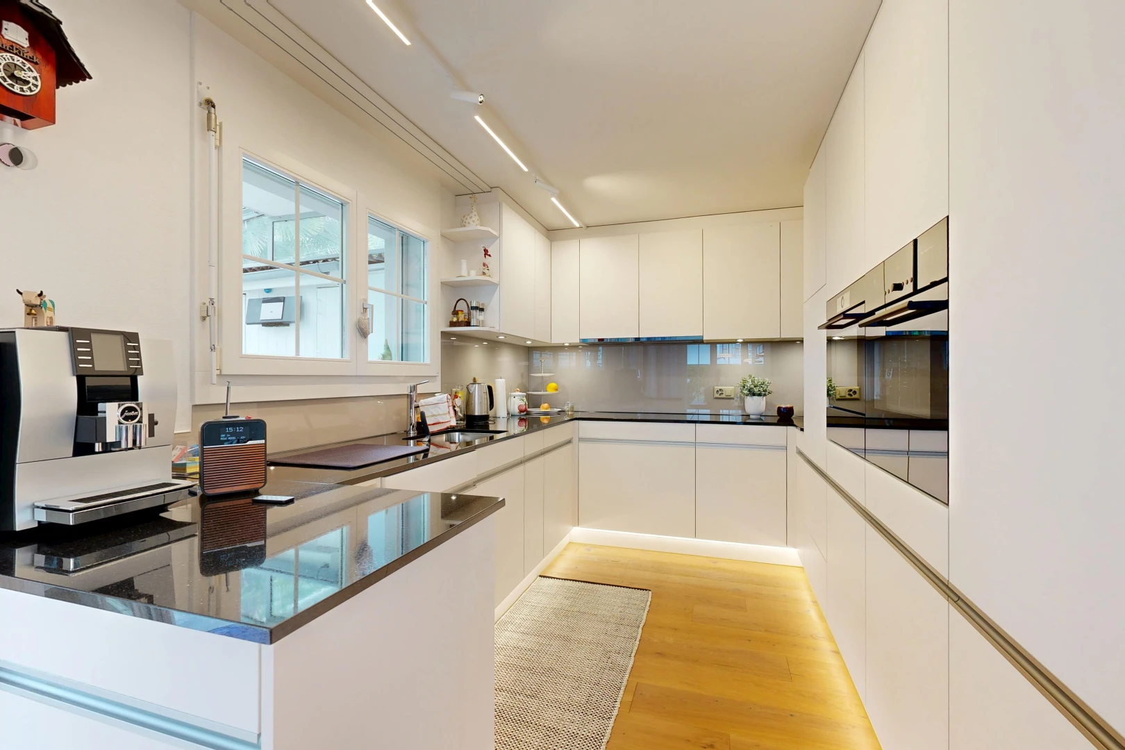 kitchen featuring open shelves, stainless steel oven, white cabinetry, modern cabinets, and a peninsula