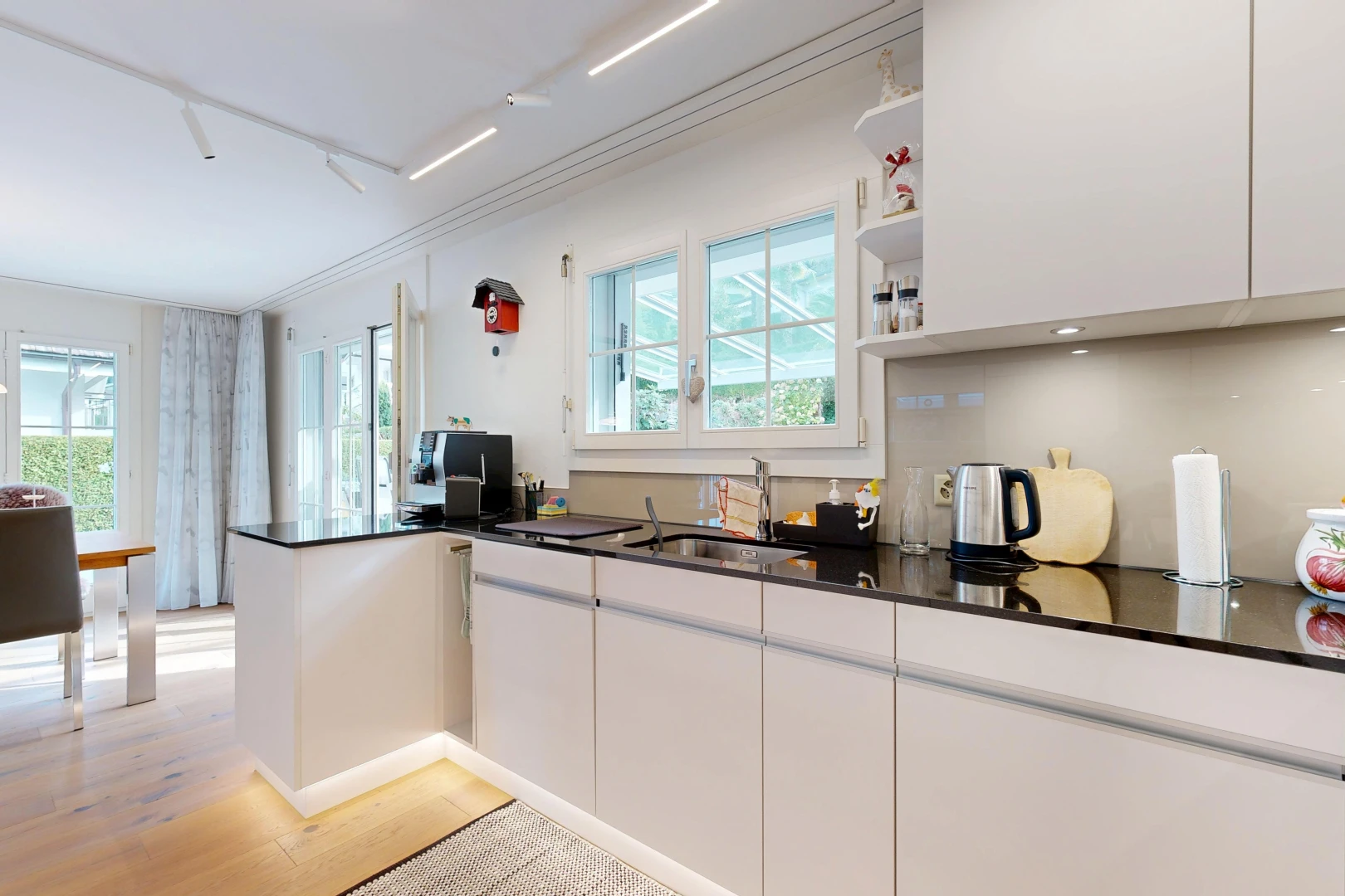kitchen with white cabinets, open shelves, plenty of natural light, and light wood-style flooring