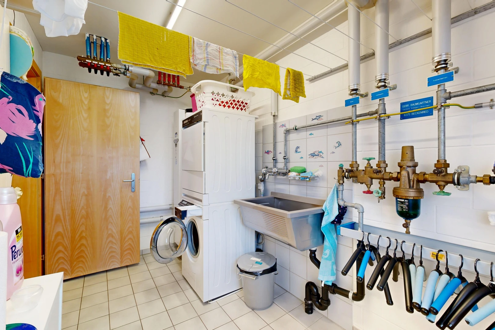 laundry area with stacked washer and dryer