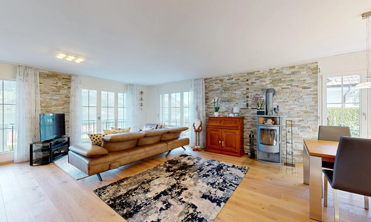 living area with a wood stove, light wood finished floors, and healthy amount of natural light