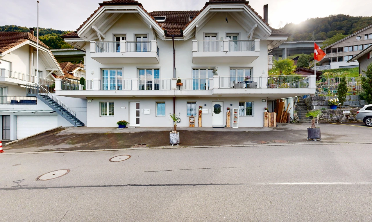 view of property featuring stucco siding and a tile roof