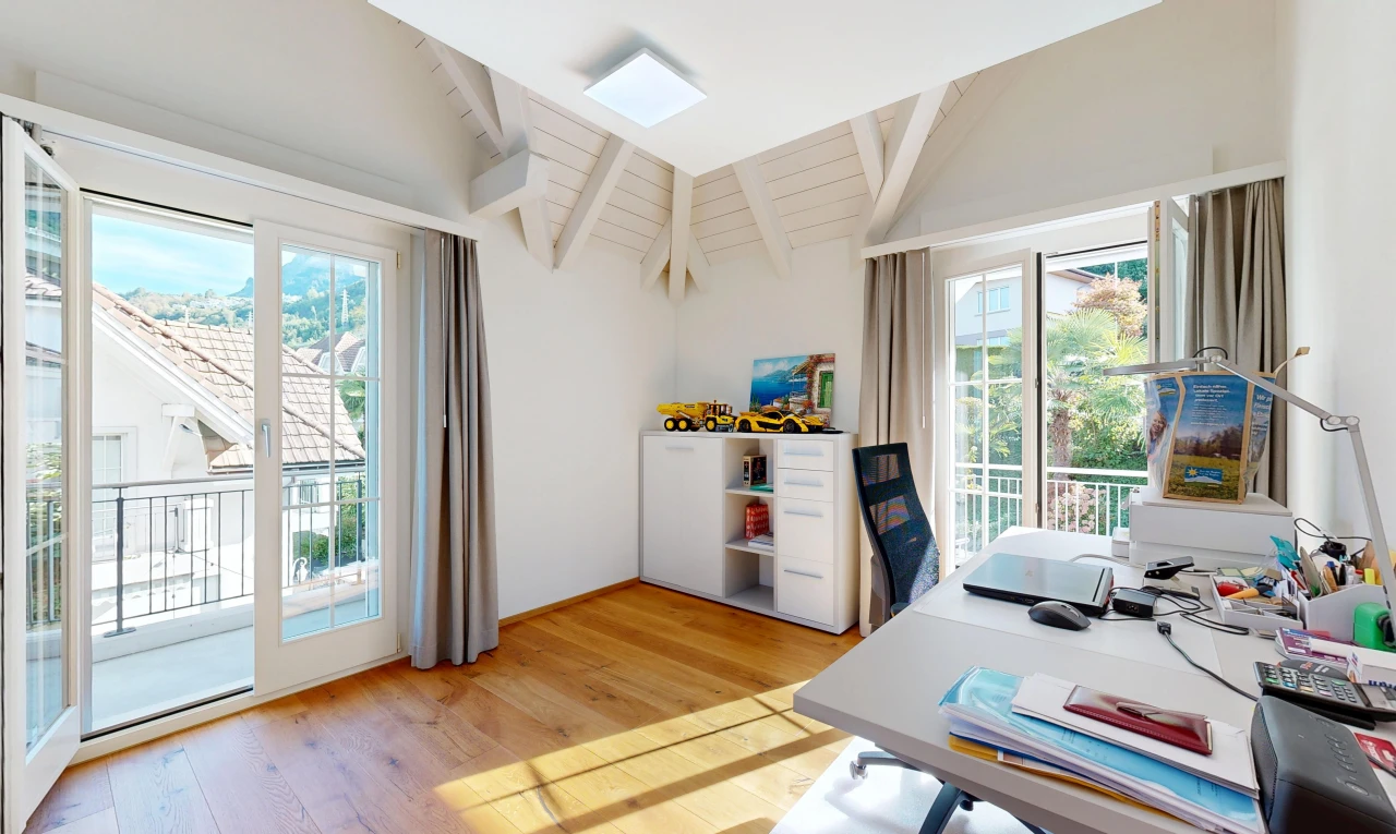 office with access to exterior, light wood-type flooring, and vaulted ceiling