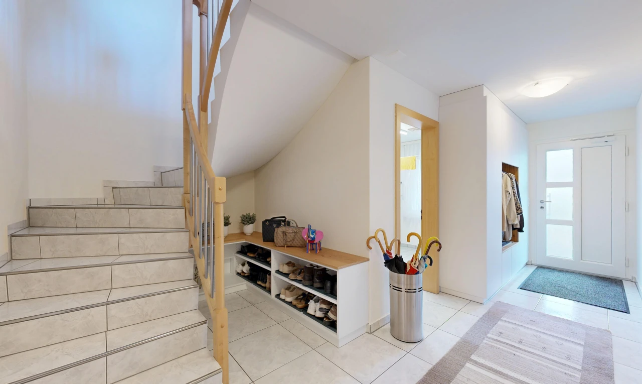 stairs with access to outside and light tile patterned floors