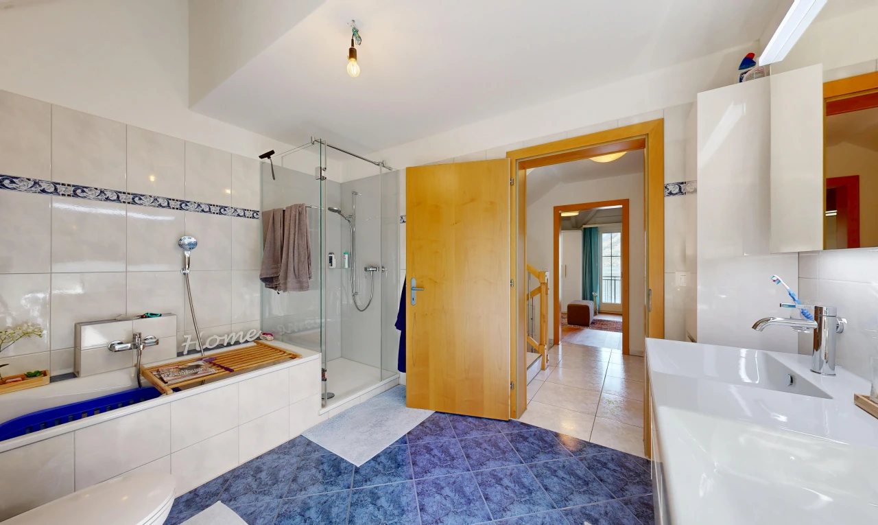 full bath with a stall shower, tile patterned floors, and vanity
