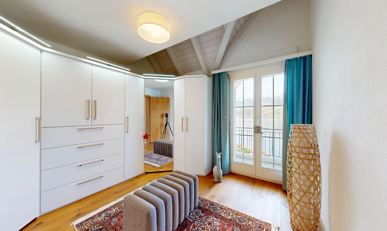 room / bedroom featuring access to exterior, light wood finished floors, french doors, and lofted ceiling