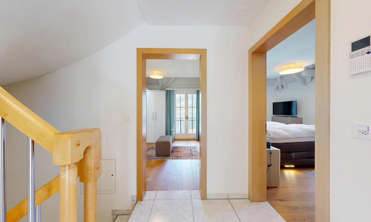 hallway featuring stairs and light tile patterned floors