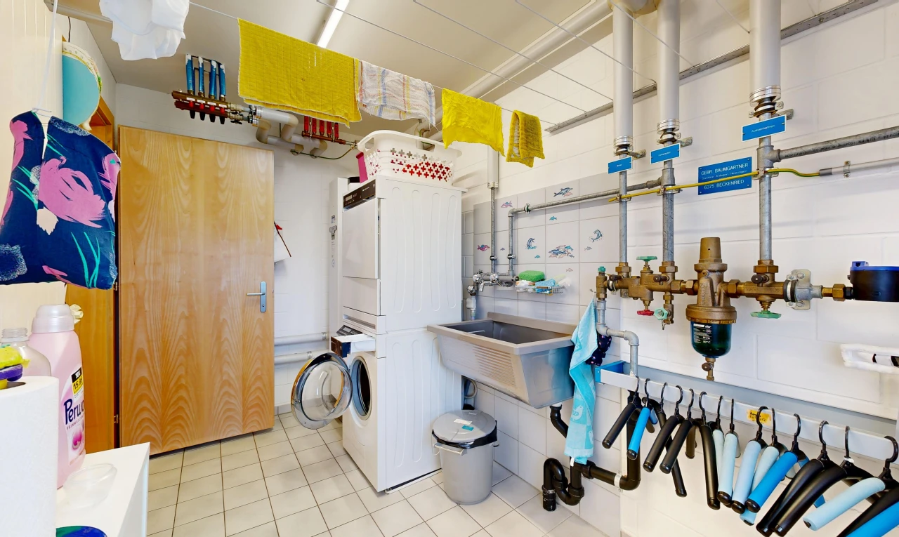 laundry area with stacked washer and dryer