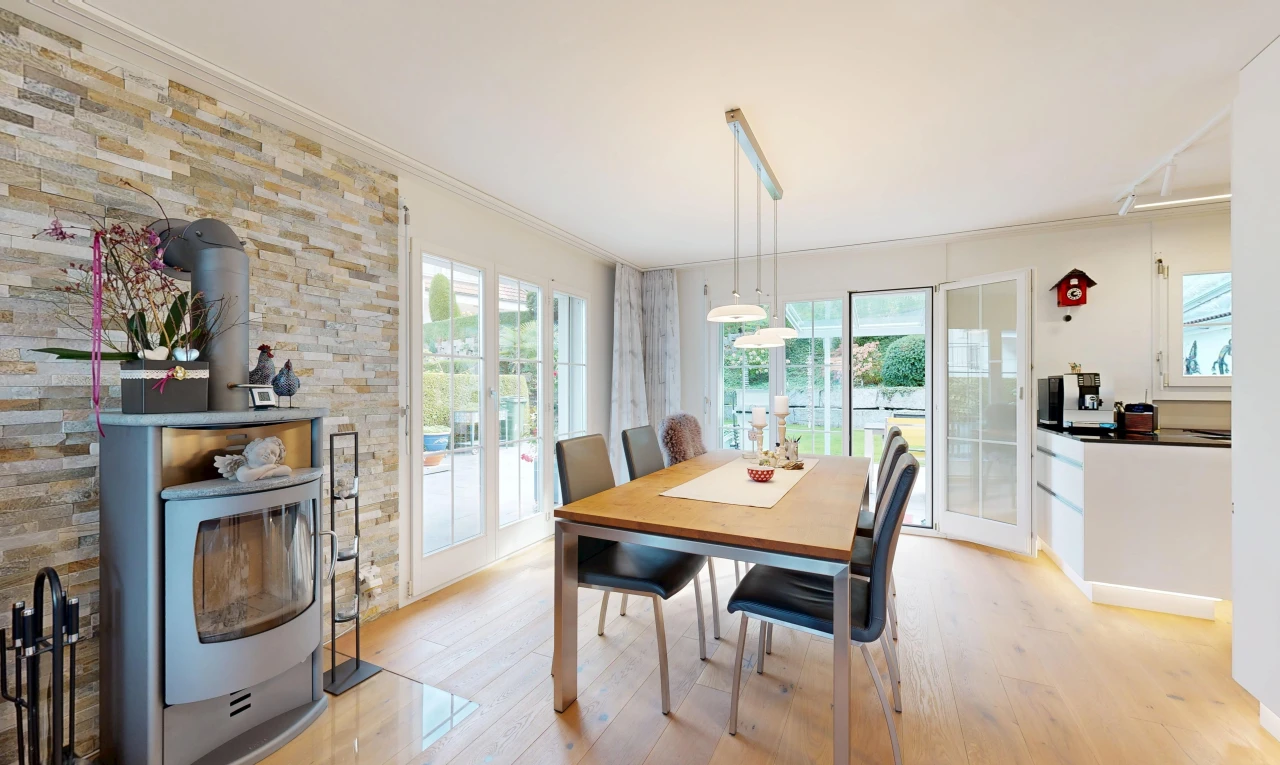 dining space featuring access to outside, light wood-style floors, ornamental molding, and hanging light fixtures