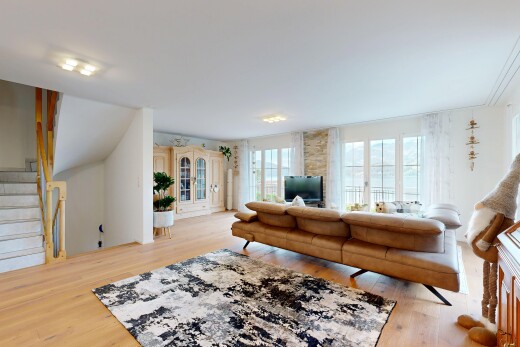 living area featuring stairway and light wood-style flooring
