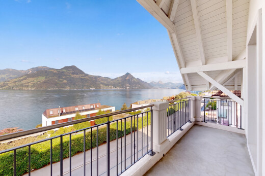 balcony featuring a water and mountain view