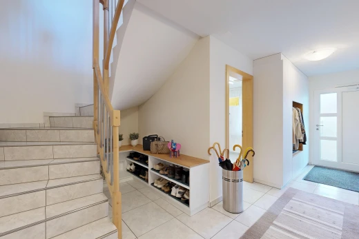 stairs with access to outside and light tile patterned floors