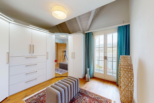 room / bedroom featuring access to exterior, light wood finished floors, french doors, and lofted ceiling