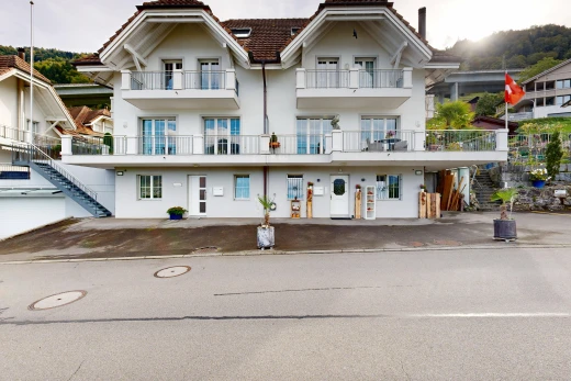 view of property featuring stucco siding and a tile roof