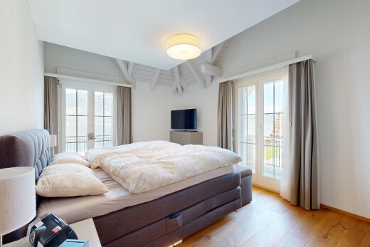 room / bedroom with access to exterior, light wood-type flooring, french doors, and vaulted ceiling