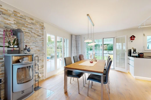 dining space featuring access to outside, light wood-style floors, ornamental molding, and hanging light fixtures