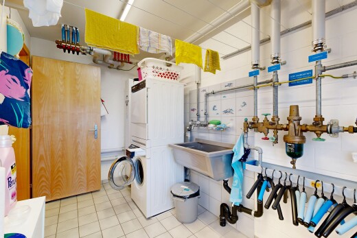 laundry area with stacked washer and dryer