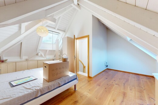 unfurnished room featuring lofted ceiling with beams and light wood-type flooring