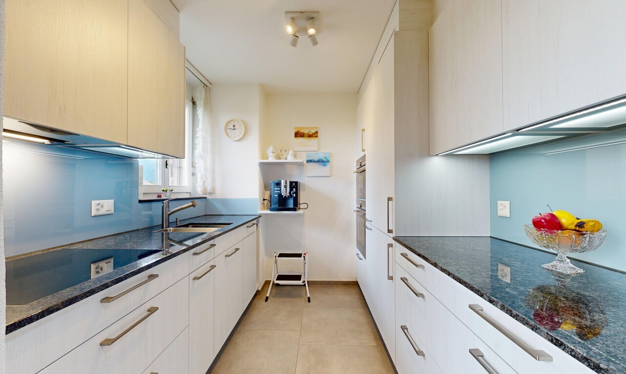 küche mit dark countertops, stein arbeitsplatten, stone countertops, light floor, und inside property