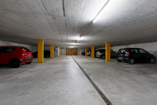 view of parking with a parking garage