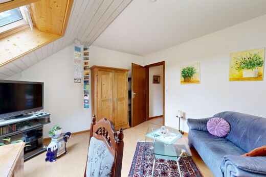 living area with a vaulted wood ceiling, a skylight, and light wood-type flooring
