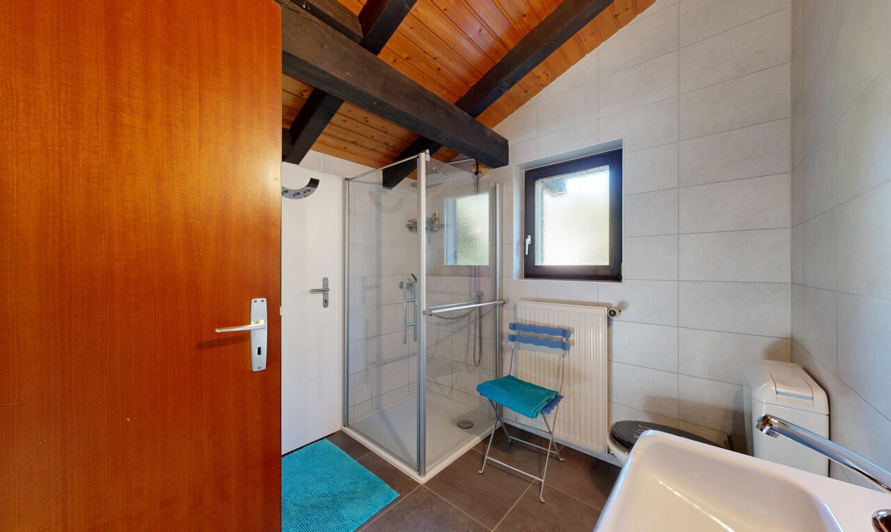 bathroom featuring radiator heating unit, a shower stall, wood ceiling, dark tile patterned floors, and tile walls