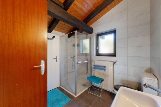 bathroom featuring radiator heating unit, a shower stall, wood ceiling, dark tile patterned floors, and tile walls