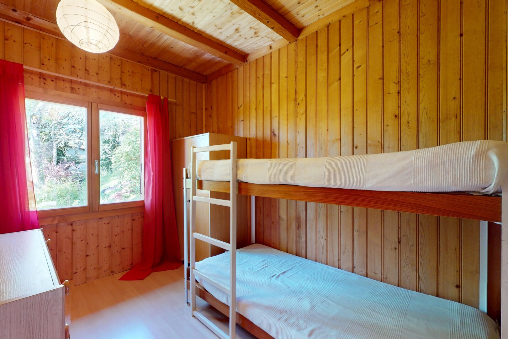 room / bedroom with wood walls, wood finished floors, beam ceiling, and wooden ceiling
