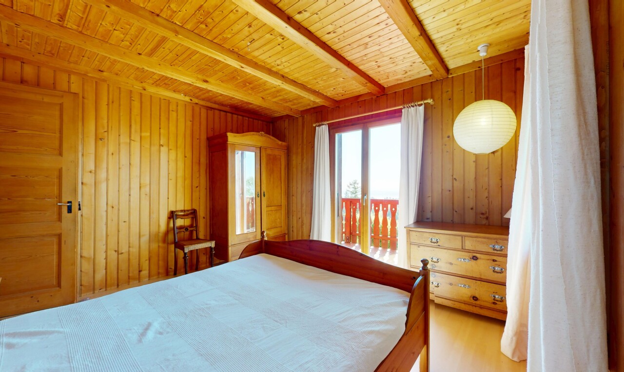 room / bedroom with wood walls and beamed ceiling