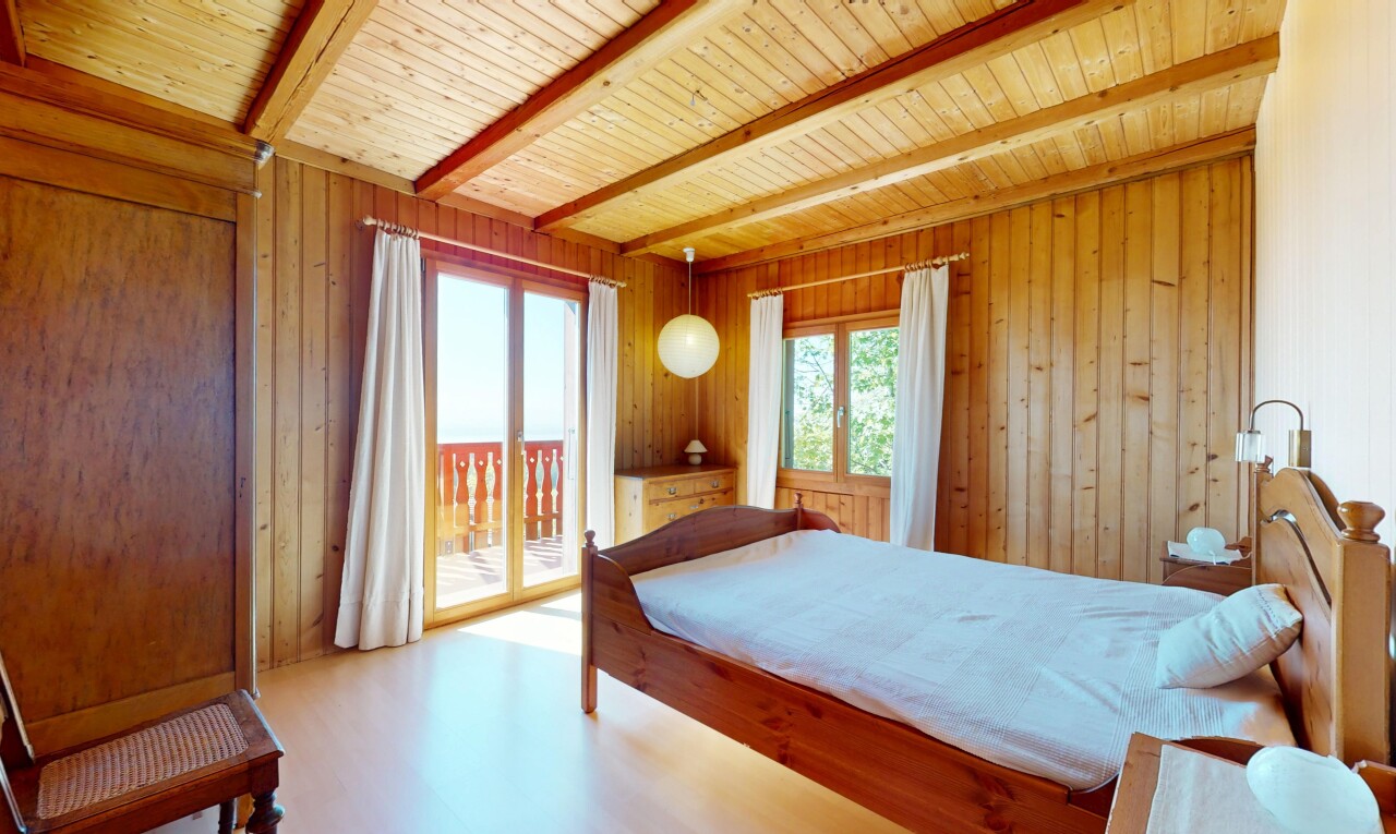 room / bedroom featuring access to outside, wooden walls, multiple windows, and beamed ceiling