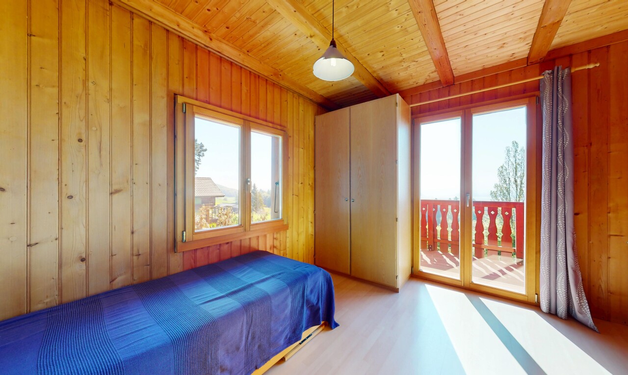 room featuring wooden walls, wood ceiling, access to outside, and wood finished floors