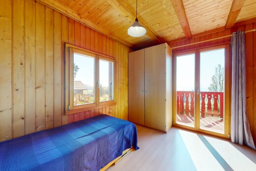 room featuring wooden walls, wood ceiling, access to outside, and wood finished floors