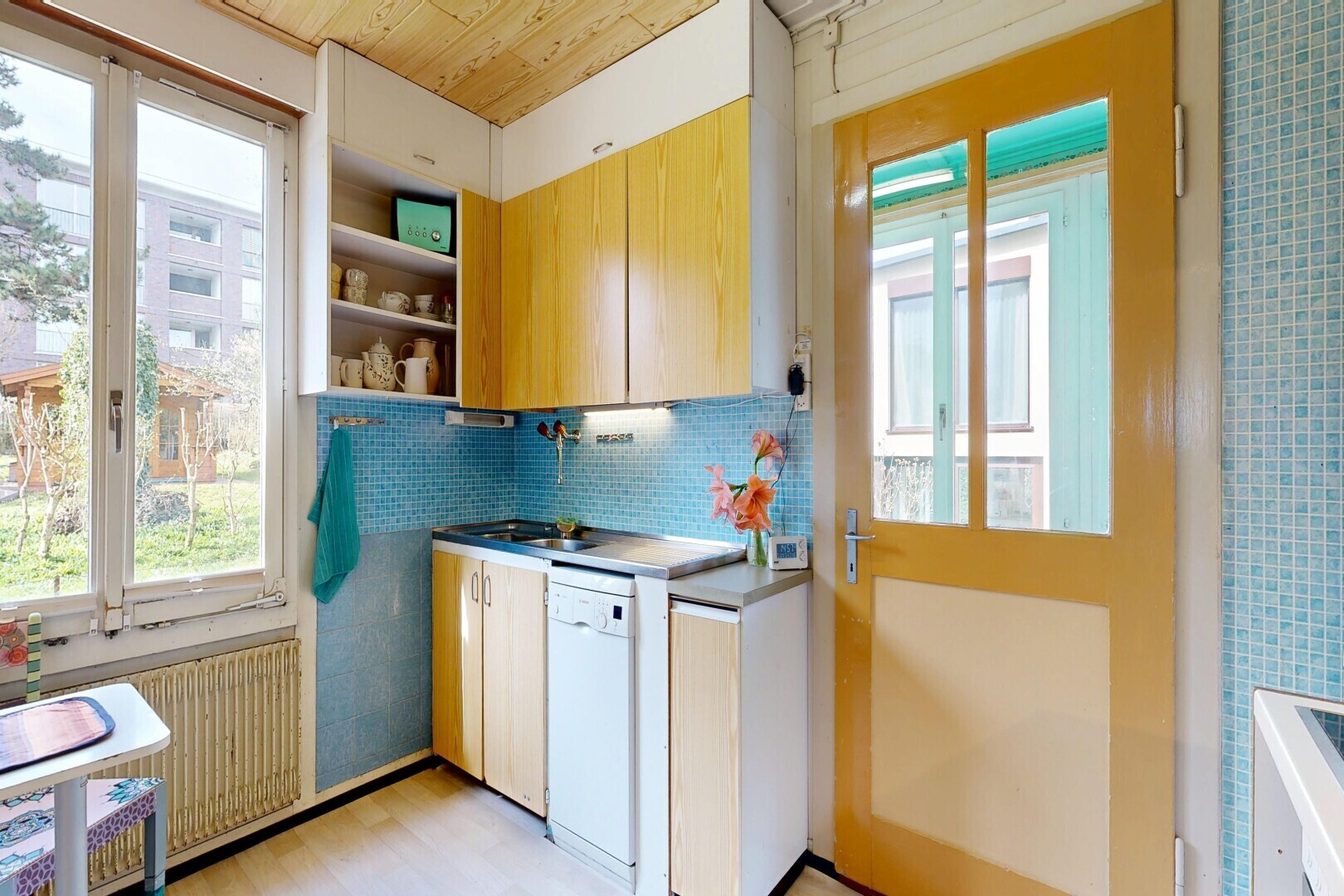 kitchen with open shelves, dishwasher, light wood-type flooring, radiator heating unit, and wood ceiling