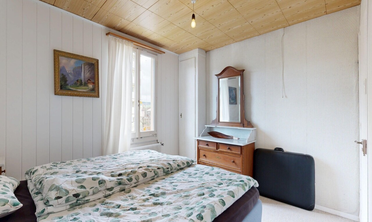 room with wooden ceiling and light carpet