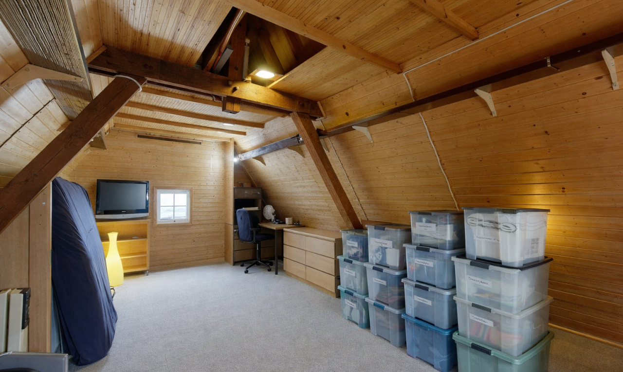 room featuring wood walls, light carpet, a wood ceiling with exposed beams, and a desk