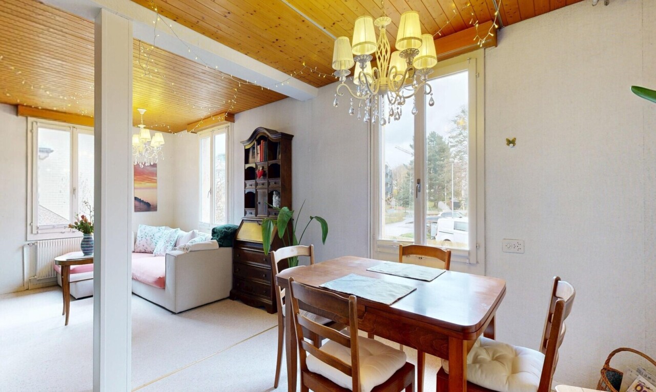 carpeted living area featuring a chandelier, wooden ceiling, plenty of natural light, and radiator