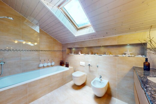 salle de bains avec puits de lumière, sol en carrelage, bidet, bain, et toilette