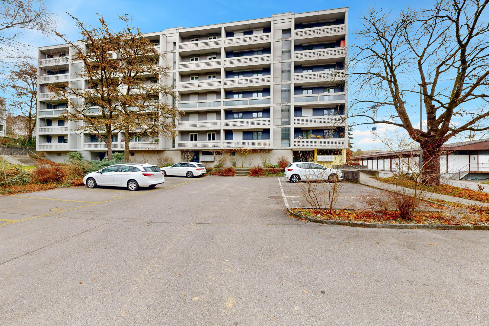 view of apartment building / complex with uncovered parking
