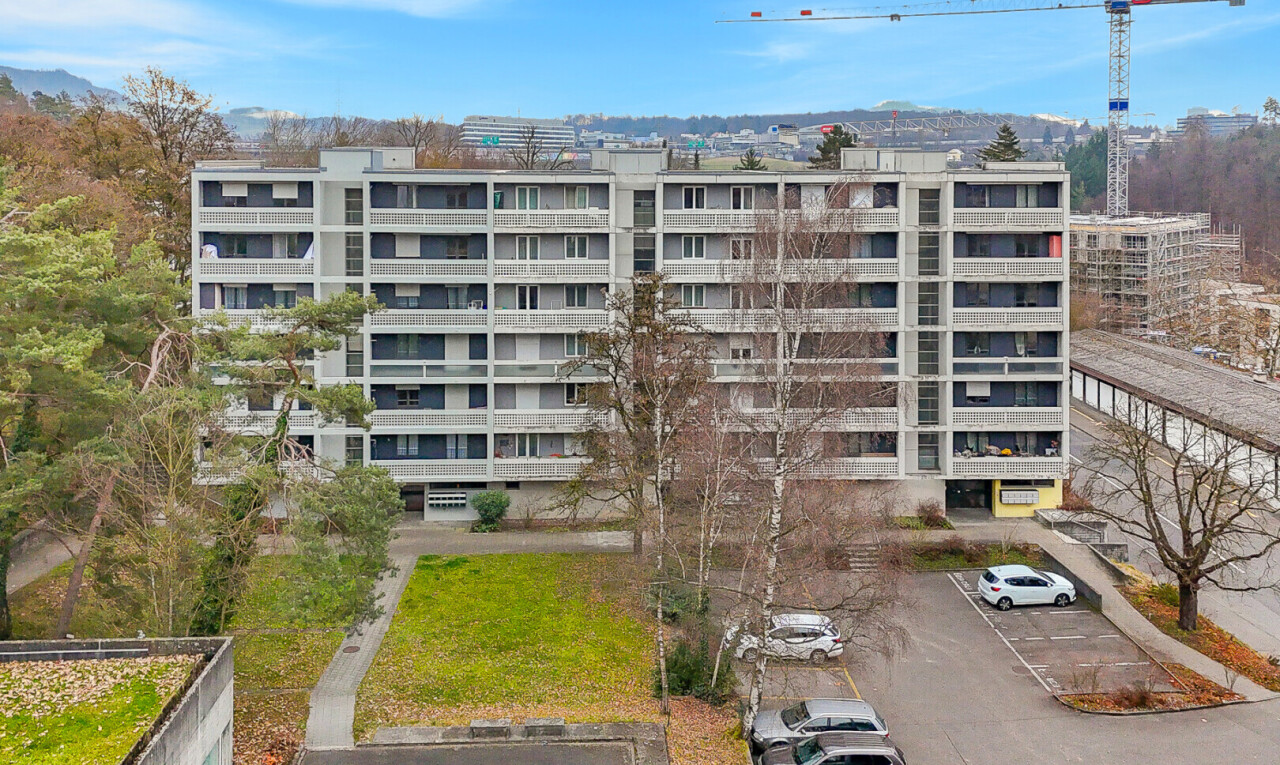 view of apartment building / complex featuring uncovered parking