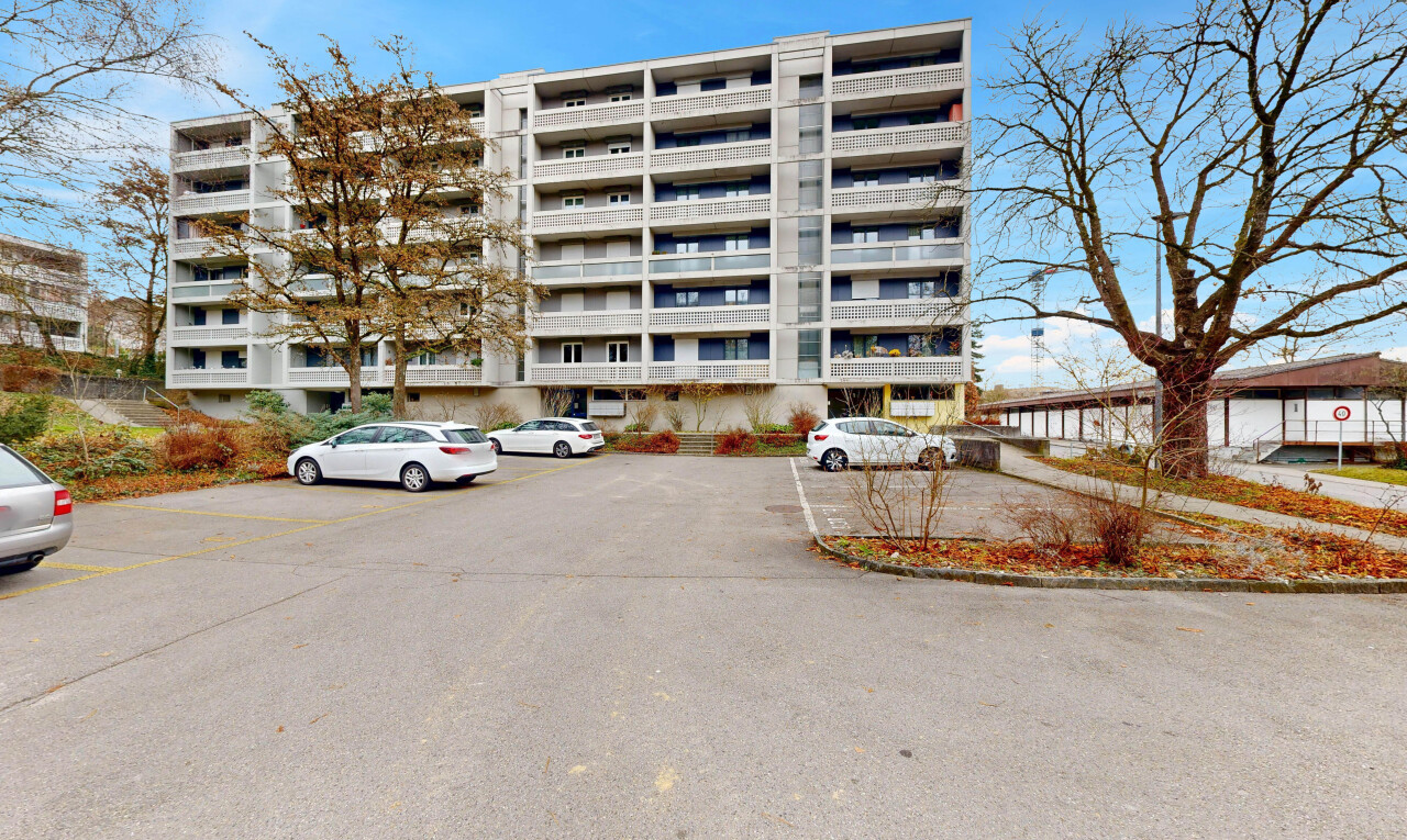 view of apartment building / complex with uncovered parking