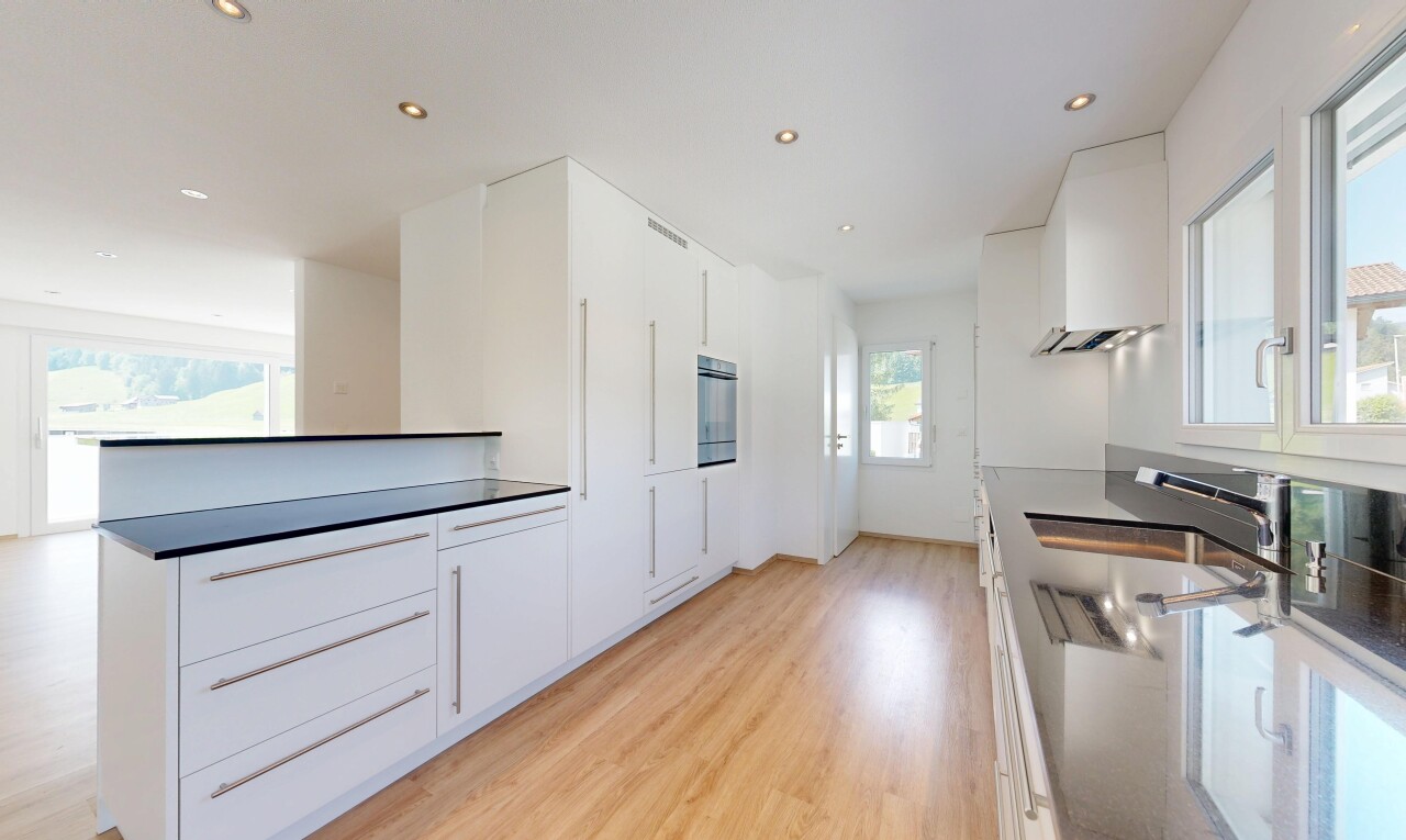 küche mit natürliches licht, einbauleuchten, two heights countertops, light floor, und dark countertops