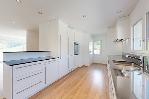 küche mit natürliches licht, einbauleuchten, two heights countertops, light floor, und dark countertops