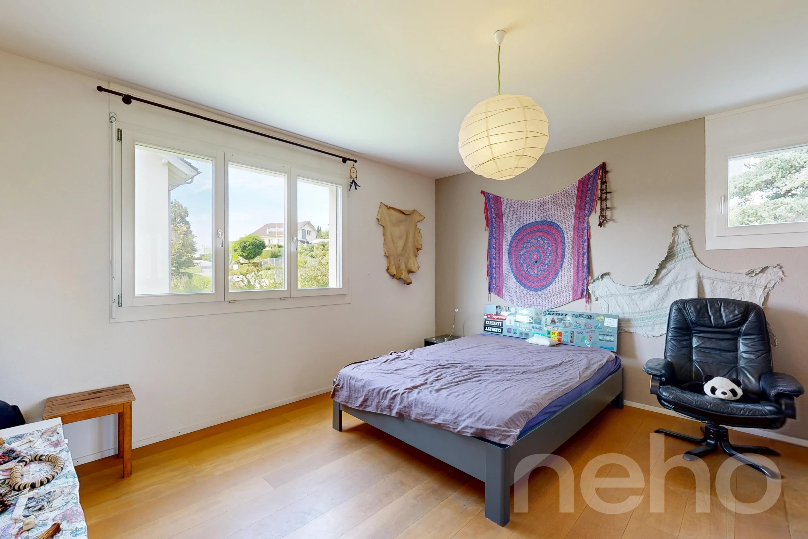 room / bedroom featuring pendant lighting and light wood-style flooring