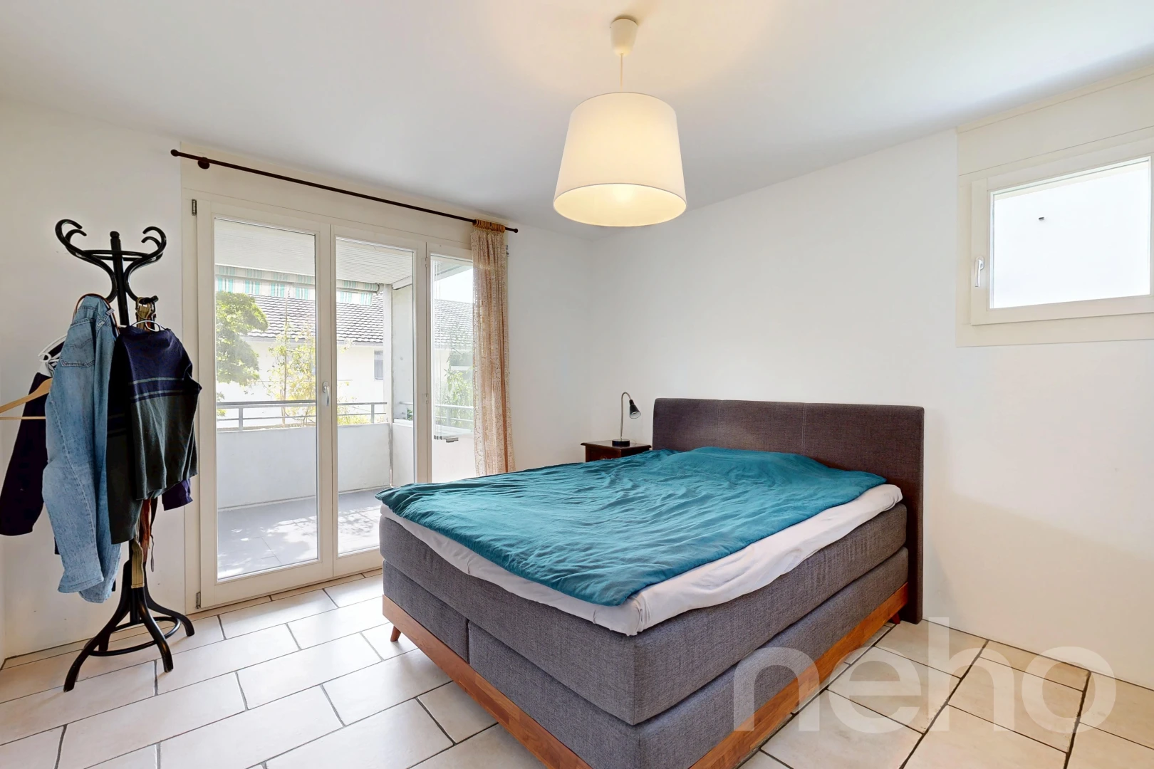 room with access to exterior, decorative light fixtures, and light tile patterned floors