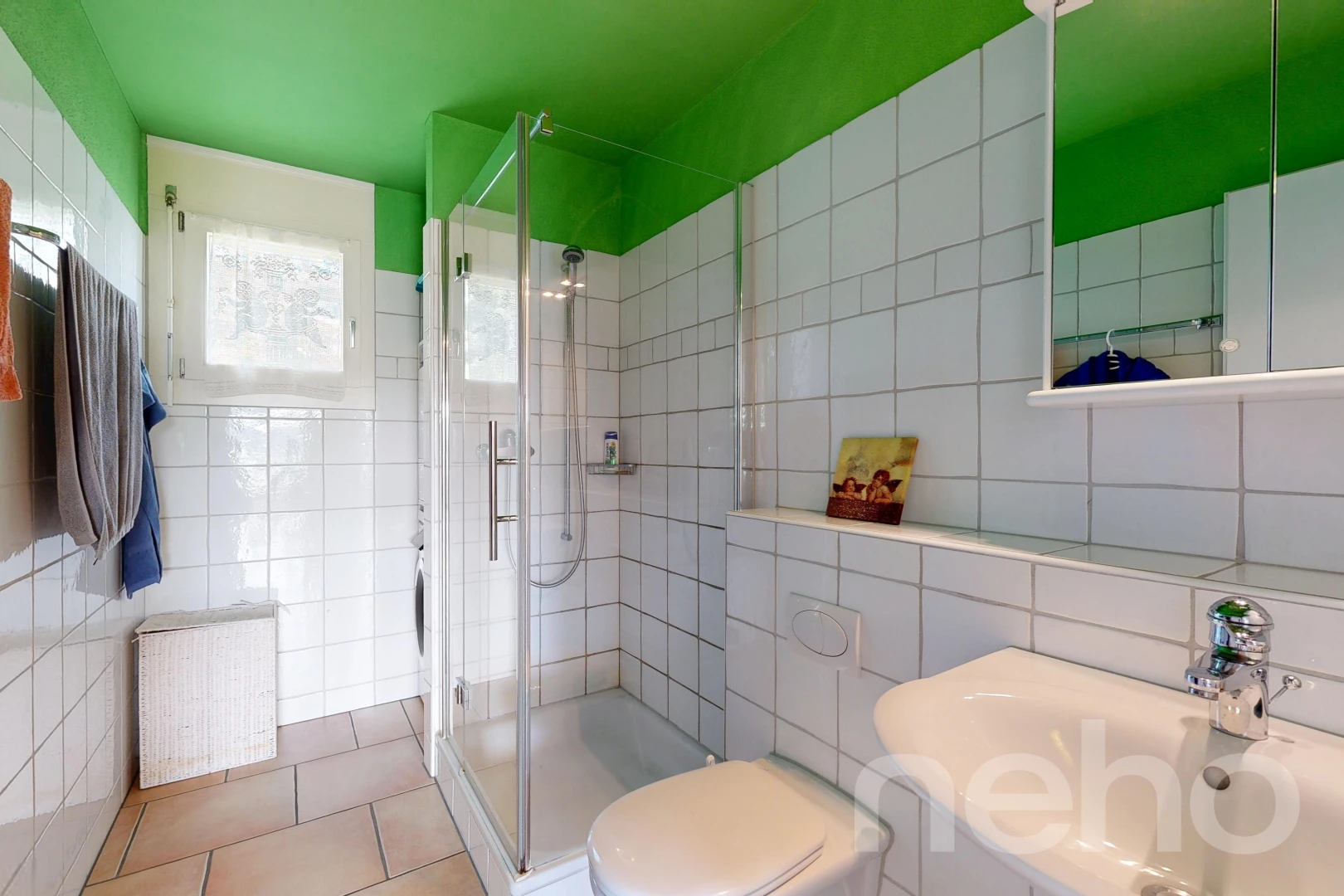 bathroom featuring a stall shower, tile walls, and light tile patterned flooring
